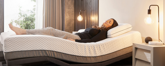 A younger female with brown hair laid in an adjustable bed in the zero gravity position