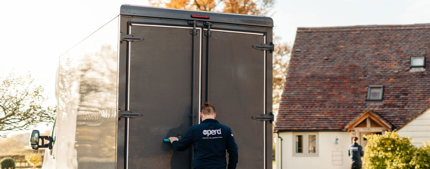 Delivery man in Opera uniform opening a delivery truck.