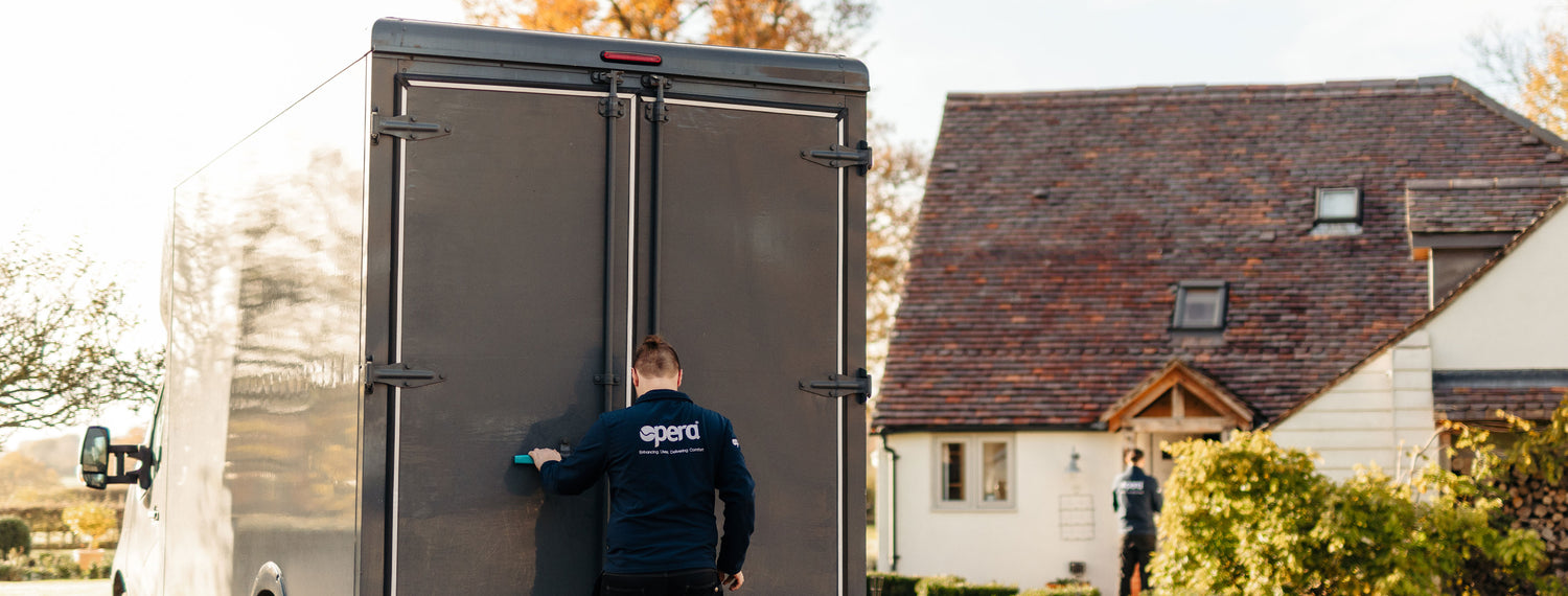Delivery man in Opera uniform opening a delivery truck.