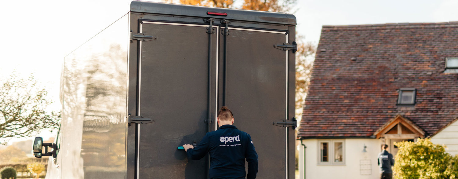 Delivery man in Opera uniform opening a delivery truck.