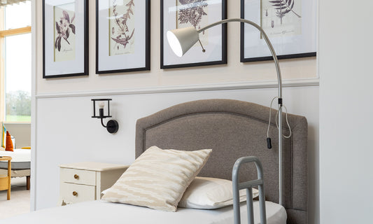 Overbed light fixed onto the side of an Opera profiling bed with grab rail