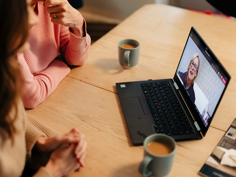 A mother and daughter on a virtual visit with an Opera advisor.