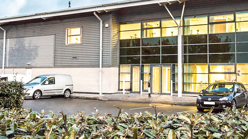 Opera Showroom building exterior and car park showing the drop curb