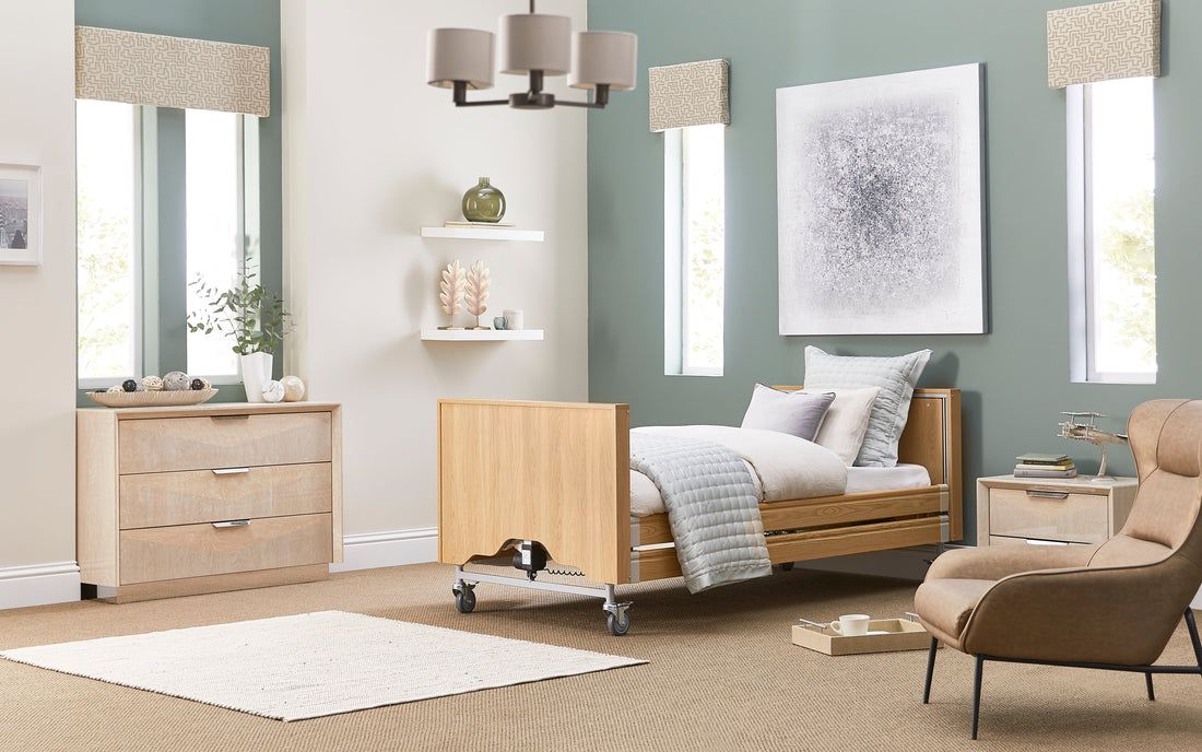 A Opera Classic profiling bed with white and cream cushions and throw