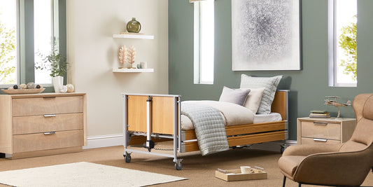 A opera classic wooden profiling bed in a bedroom with green painted walls