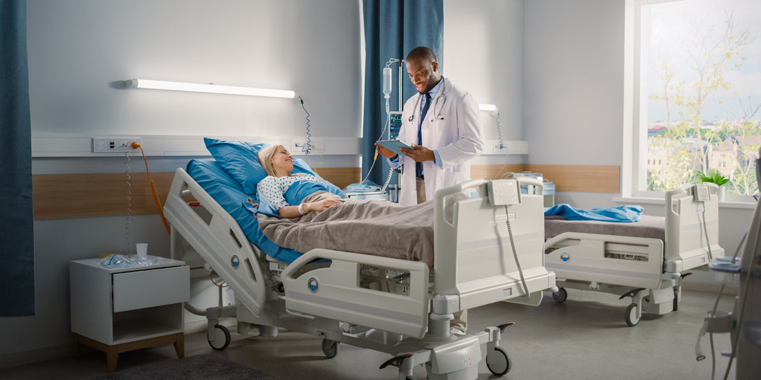 A younger female lying in a hospital bed with the doctor stood beside him