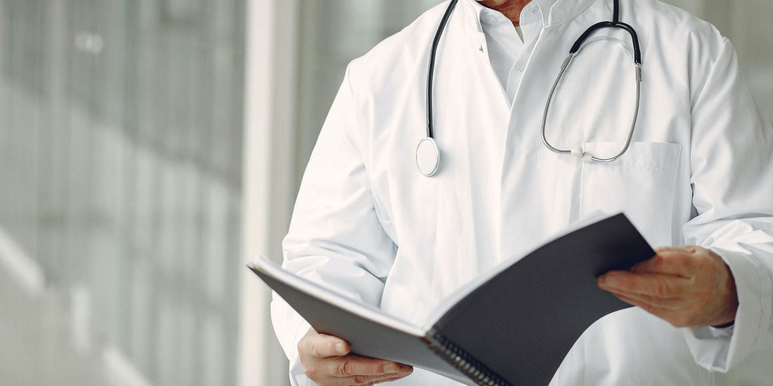 A doctors holding a document wearing a white uniform and a stethoscope