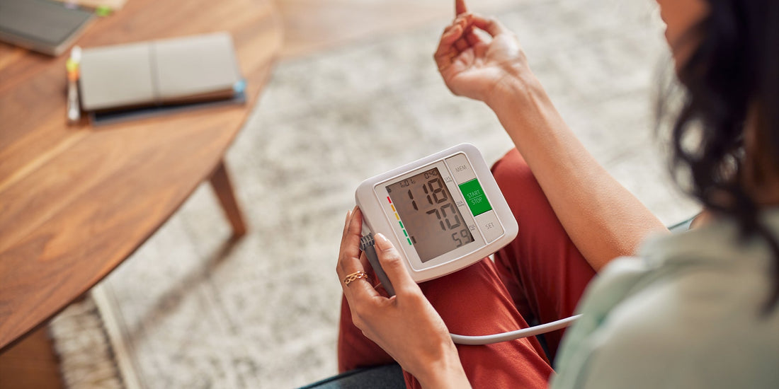 A younger lady taking her blood pressure at home 