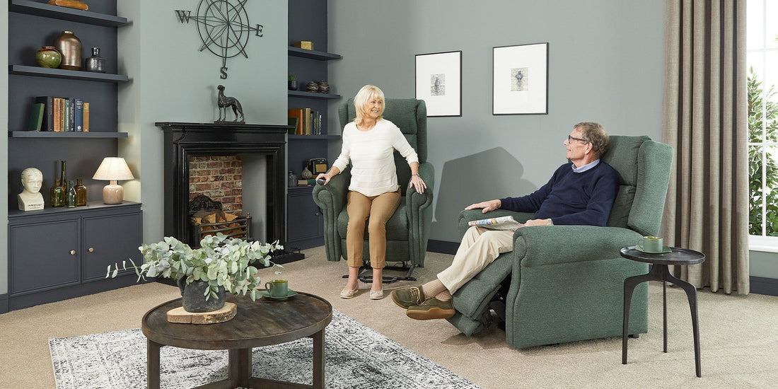 A older couple sat in an opera riser recliner chair in a green woven fabric