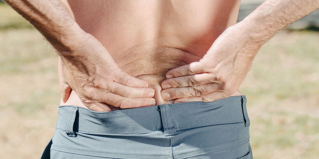 A man holding his lower back 