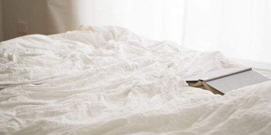 A white bedsheet with a book 