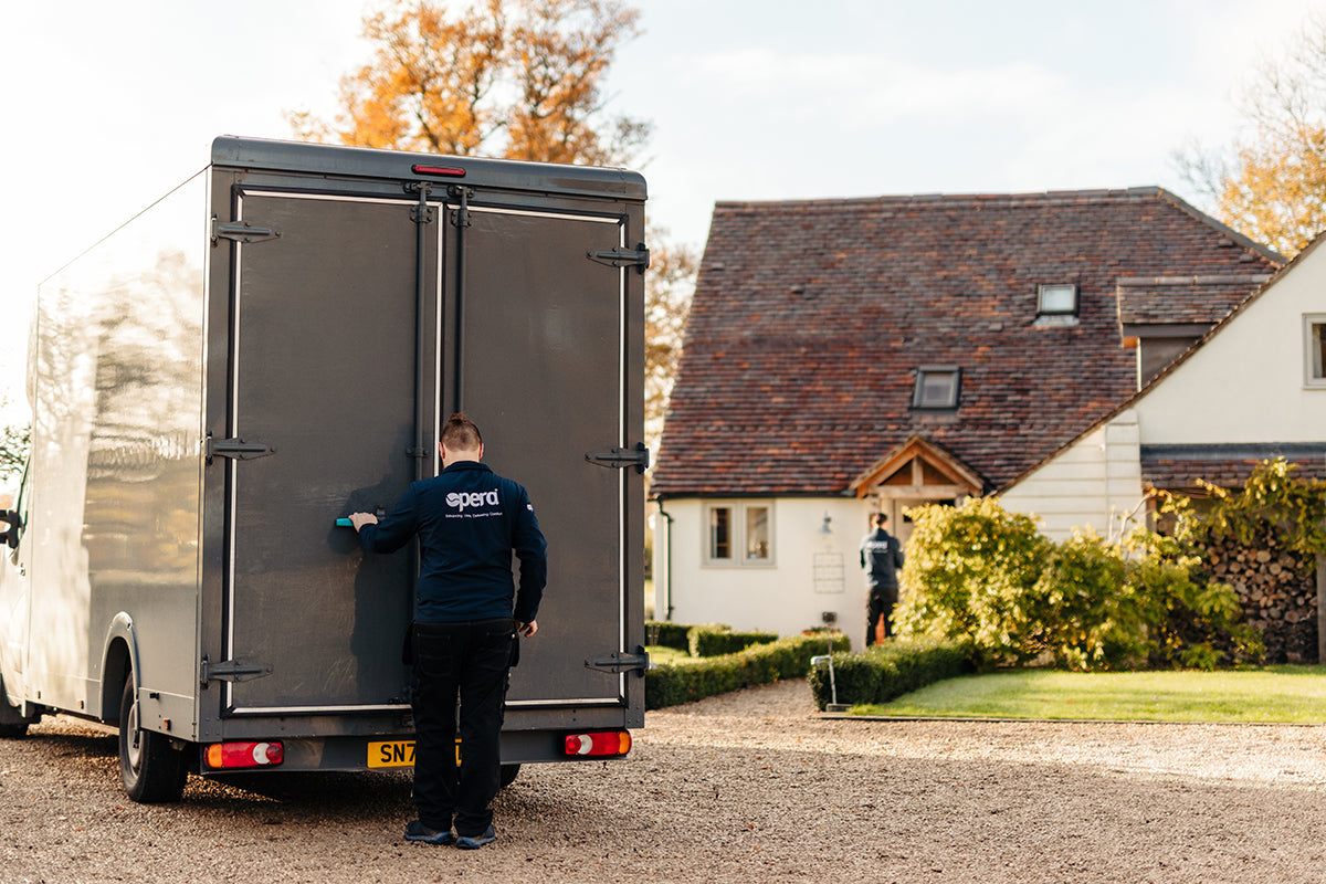 Opera delivery driver opening the back of a delivery van