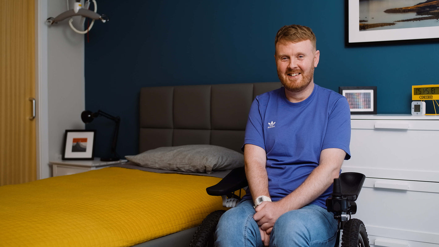 Opera customer Niall Harris, sat in a wheelchair next to his profiling bed