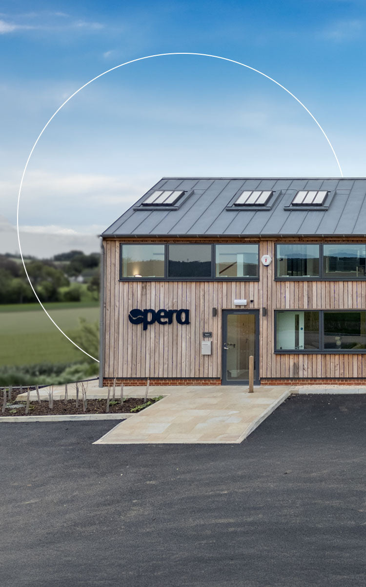 Modern building with 'opera' branding on a clear day