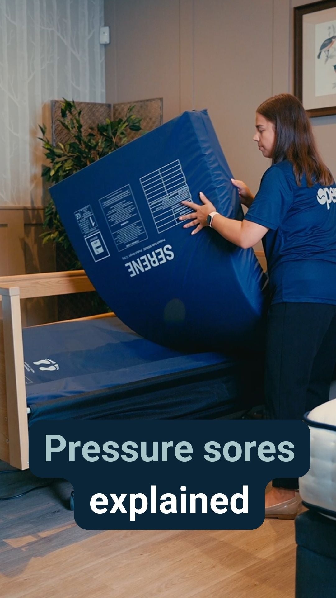 An Opera advisor laying a pressure care mattress onto a profiling bed with the caption 'pressure sores explained'