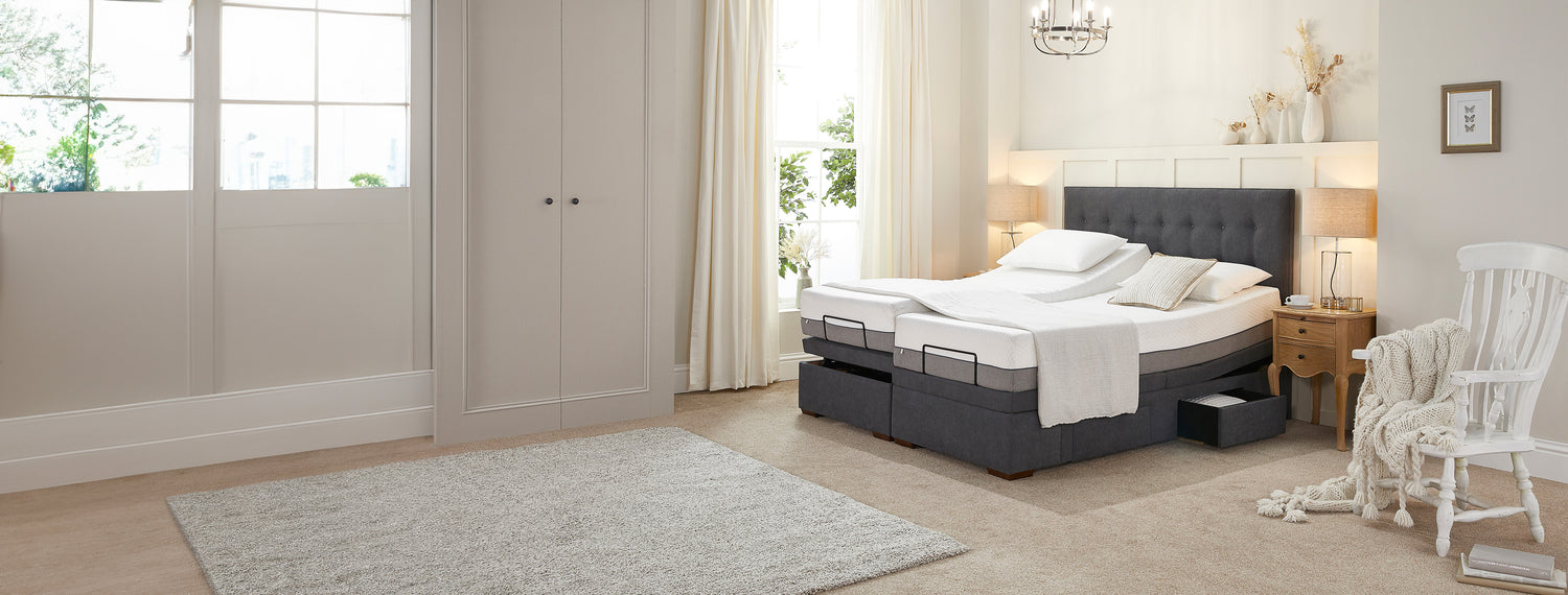 Dual adjustable bed with storage drawer open and one mattress profiled