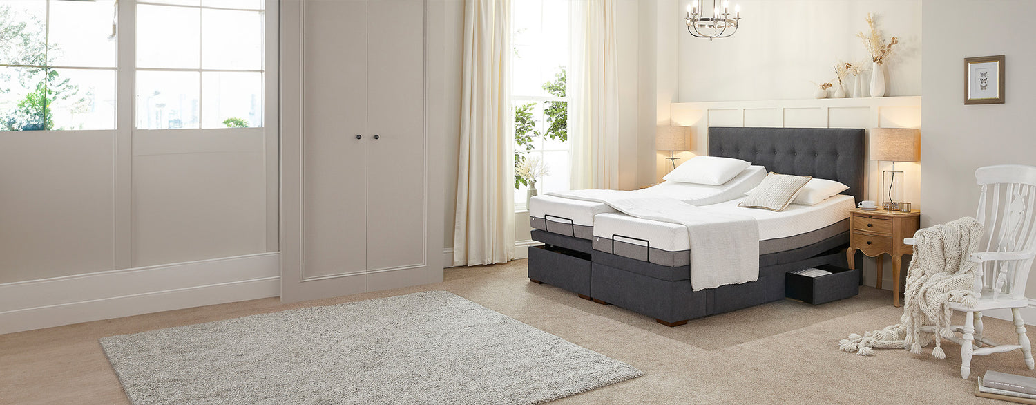 Dual adjustable bed with storage drawer open and one mattress profiled