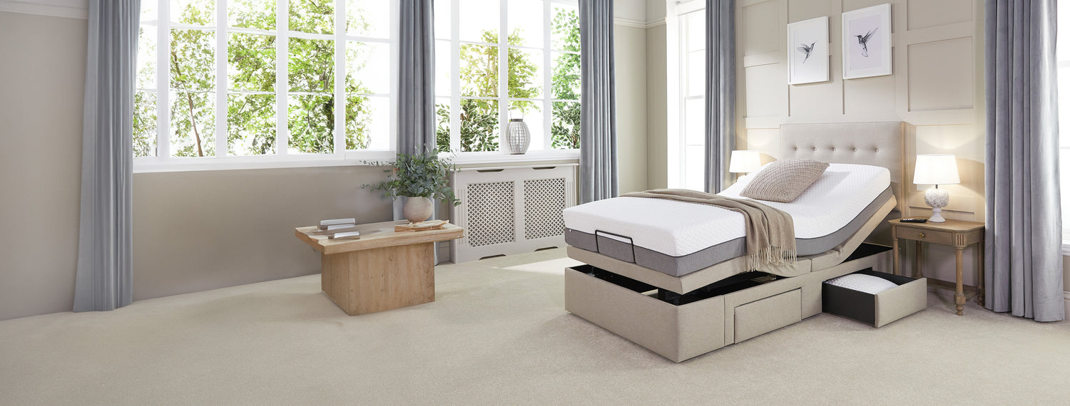 Adjustable single divan bed with a storage drawer open