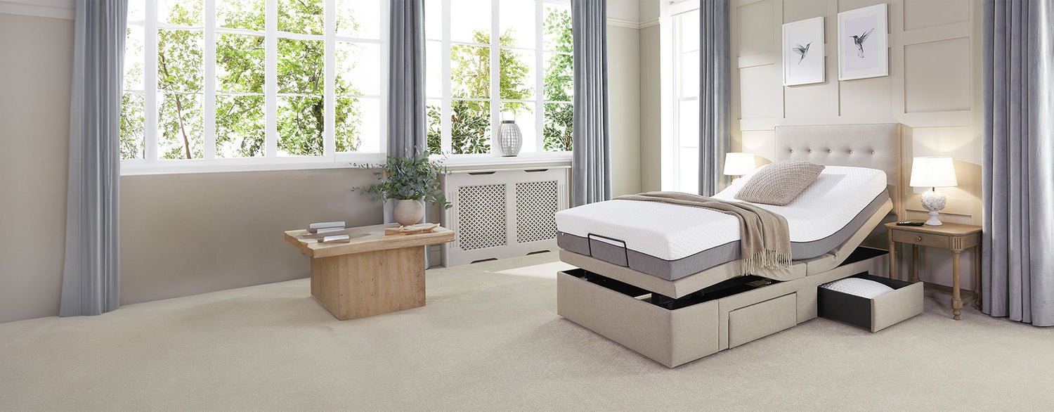 Adjustable single divan bed with a storage drawer open