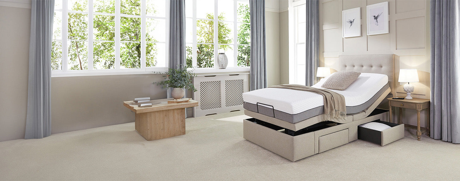 Adjustable single divan bed with a storage drawer open